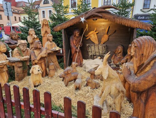 A nativity scene carved from wood.
